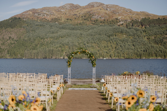 Sunflower-decorated waterside ceremony with Loch Goil in background